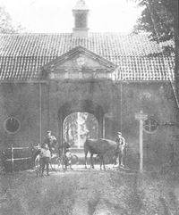 Voor het poortgebouw van Rhijnauwen staat Arie Knoppers met zijn kinderen. De man met paard is vermoedelijk Van Dijk van boerderij het Goet ten Rijn.
