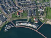 Luchtfoto van de Visserswoningen aan het Overdamsepad en de Vlondertuin in 2018 bij de Rietplas. Foto: Slagboom en Peeters Luchtfotografie B.V.