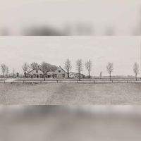 Gezicht over een weiland op de voorgevel van een boerderij met bijgebouwen aan de Beusichemseweg in 't Goy naast de hekpalen aan het begin van de oprijlaan naar Wickenburgh. Naar een tekening van O.J. Wttewaall. Bron: RAZU, 353.