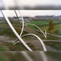 Kunstwerk C.Y.F. (spaghetti-buizen) met op de achtergrond basisschool de Vlaswiek in 1994. Bron: Regionaal Archief Zuid-Utrecht (RAZU), 353.