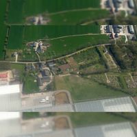 Luchtfoto gezien vanuit het westen met onderaan het kassencomplex van Jongerius met rechts de Algemene Begraafplaats aan de Oud Wulfseweg. Met linksboven huis Nieuw-Wulven met rechts daarnaast boerderij Oud-Wulverbroek, gezien in het voorjaar in 2019. Foto: Slagboom en Peeters Luchtfotografie B.V..