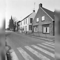 Gezicht op de panden Loerikseweg 8 (rechts) -lager te Houten, met op de achtergrond de toren van de Nederlands-Hervormde kerk (Lobbendijk 1) in 1975. Bron: Het Utrechts Archief, catalogusnummer: 857011.