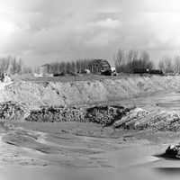 Afbeelding van het opspuiten van zand voor het tracé van de S15 (de secundaire provinciale weg Utrecht-IJsselstein) in polder de Galecop te Nieuwegein op donderdag 7 februari 1974. Bron: Het Utrechts Archief, catalogusnummer: 843802.