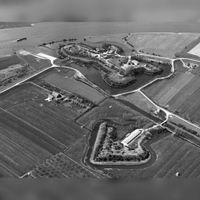 Luchtfoto van de Stelling van Honswijk met Fort Lunet aan de Snel gezien vanuit het noordoosten uit in de jaren zeventig van de vorige eeuw. Links de boerderij De Stenen Kamer. Bron: RCE, beeldbank.
